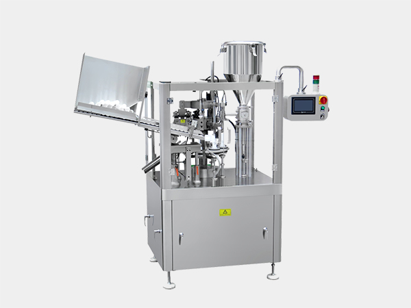 Tube filling and sealing machine
